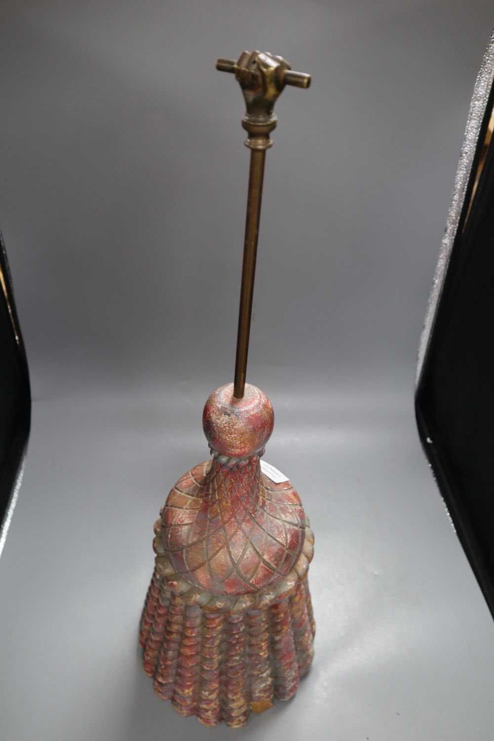 A coloured and carved wood door porter, the brass handle with clenched fist finial, height 71cm